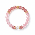 Pink quartz and strawberry crystal bracelet on a white background