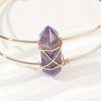 Close-up of purple faceted stone and gold wire wrapping