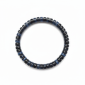 Side view of the blue tiger eye bracelet standing in a small circle showing bead thickness and waves of blue chatoyant light