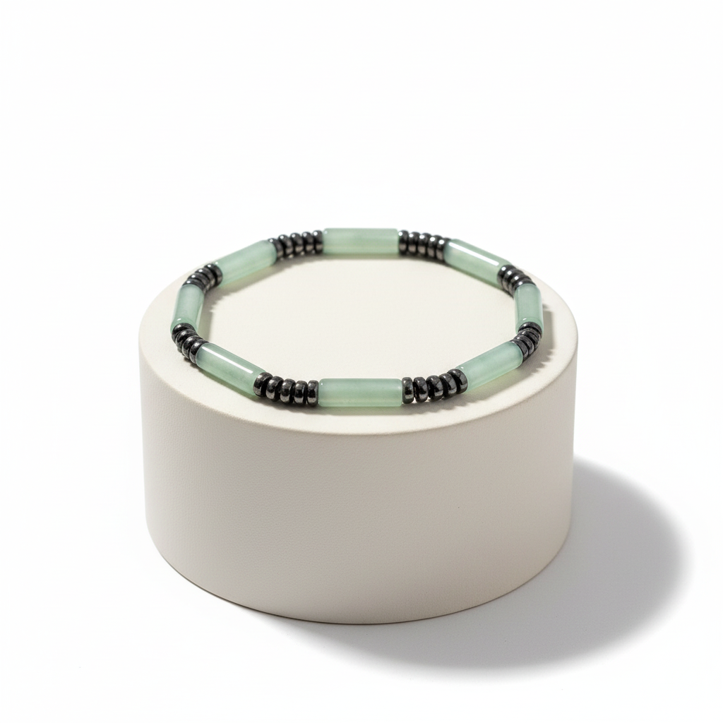 Pale mint green tube bead bracelet on a minimalist display